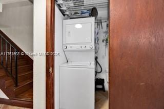 clothes washing area with laundry area and stacked washer / drying machine