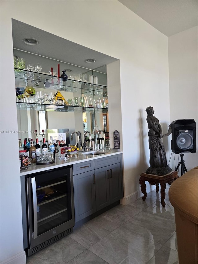 bar featuring wet bar, beverage cooler, and a sink