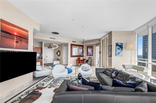 living room featuring a chandelier and visible vents