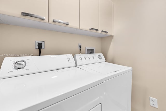 washroom with washer and dryer and cabinet space