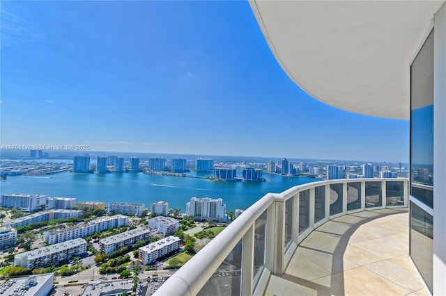 balcony with a view of city and a water view