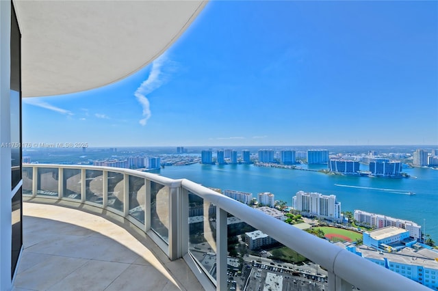 balcony with a view of city and a water view