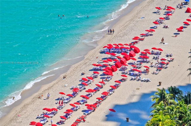 birds eye view of property featuring a beach view and a water view