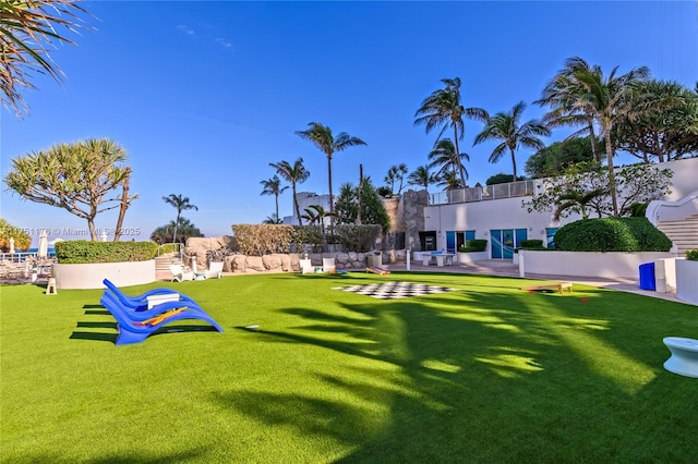 surrounding community with a yard