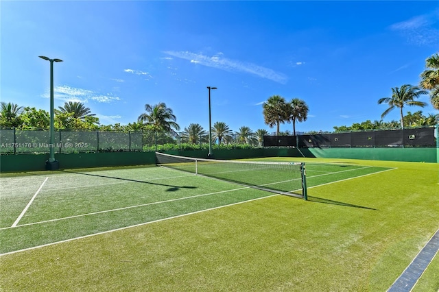 view of sport court featuring fence