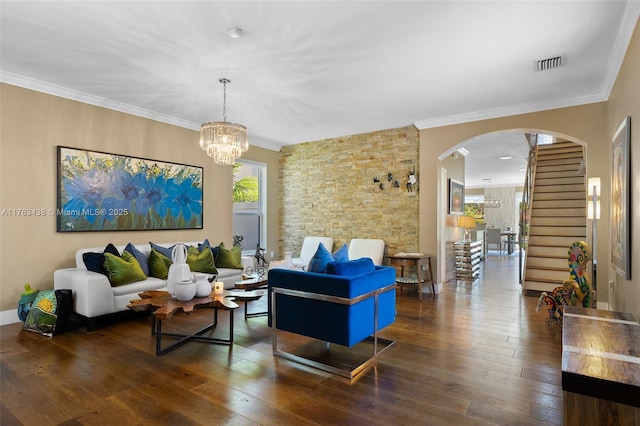 living room featuring arched walkways, visible vents, ornamental molding, and hardwood / wood-style flooring