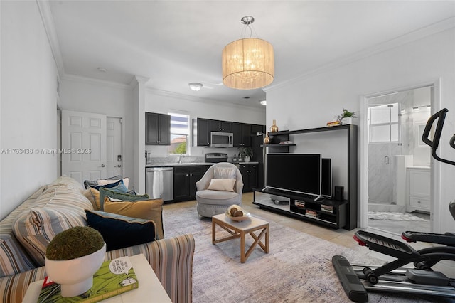 living area with light tile patterned floors, a chandelier, and ornamental molding