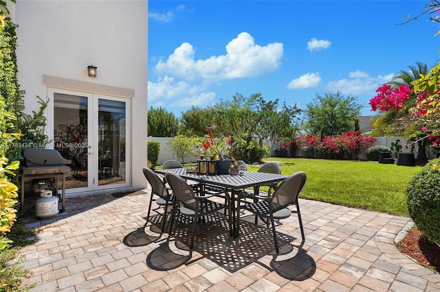 view of patio / terrace featuring outdoor dining space, area for grilling, french doors, and fence