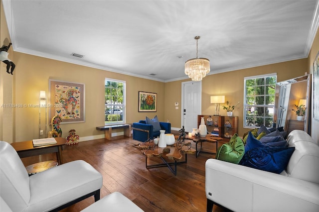 living room with hardwood / wood-style flooring, ornamental molding, visible vents, and a chandelier