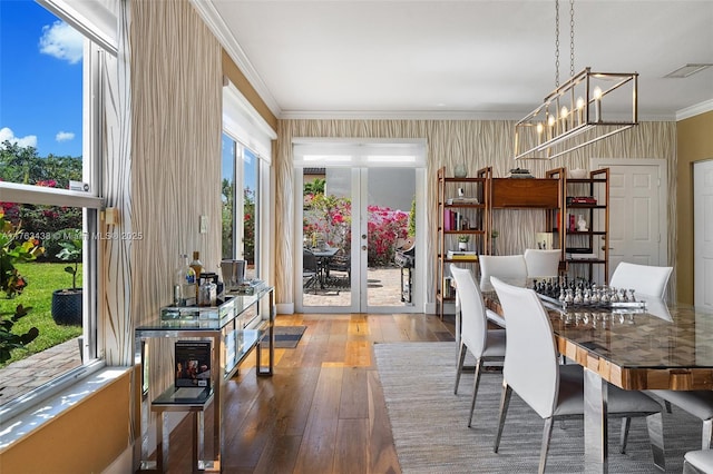 dining room with french doors, visible vents, wood-type flooring, and ornamental molding