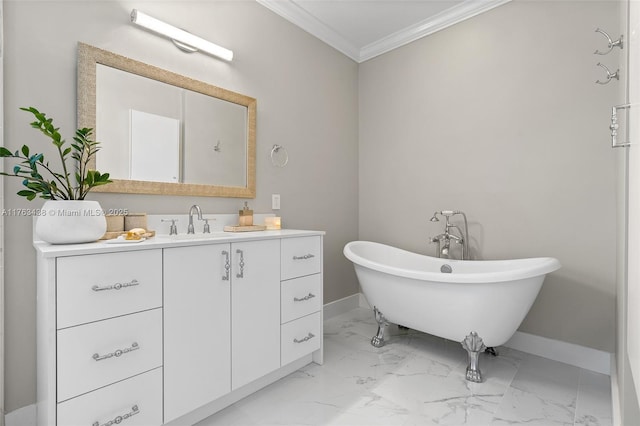 bathroom with vanity, baseboards, a freestanding bath, crown molding, and marble finish floor