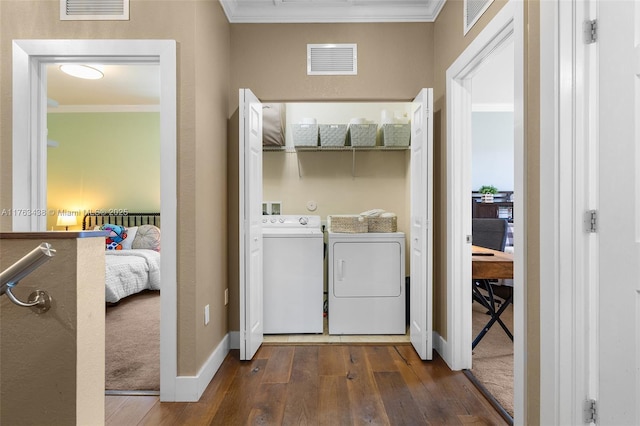 laundry area with laundry area, crown molding, visible vents, and washer and clothes dryer