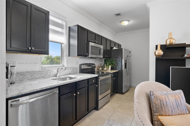 kitchen featuring visible vents, ornamental molding, light tile patterned floors, stainless steel appliances, and a sink