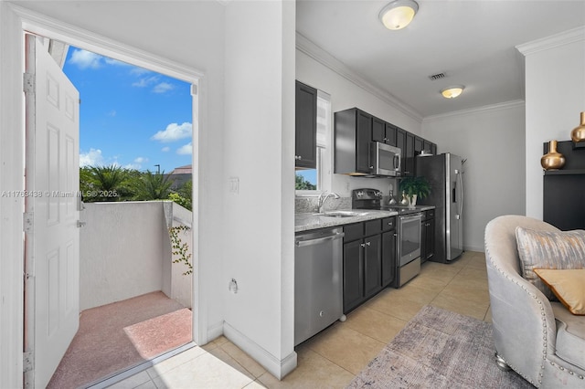 kitchen with stainless steel appliances, dark cabinetry, visible vents, and ornamental molding