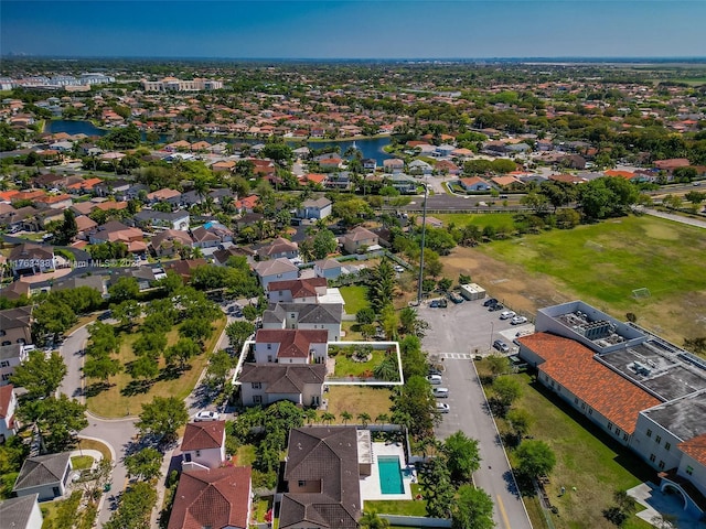 drone / aerial view with a residential view and a water view