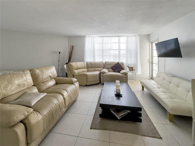 living area with light tile patterned floors and a textured ceiling