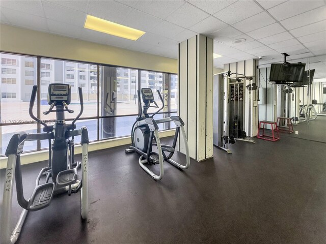 workout area with a paneled ceiling