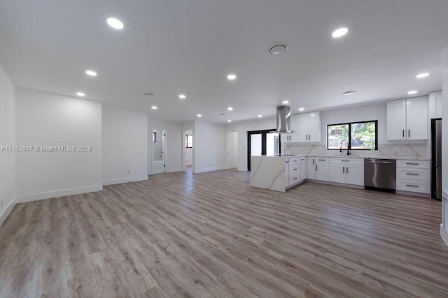 kitchen featuring open floor plan, recessed lighting, island range hood, white cabinetry, and stainless steel dishwasher