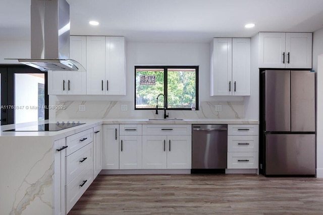 kitchen featuring a sink, white cabinets, appliances with stainless steel finishes, and island range hood