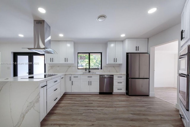 kitchen featuring a sink, stainless steel appliances, recessed lighting, and island range hood