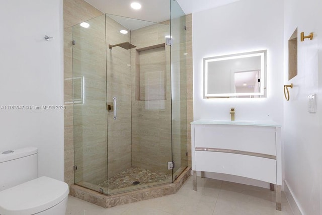 bathroom with toilet, a stall shower, vanity, and tile patterned flooring