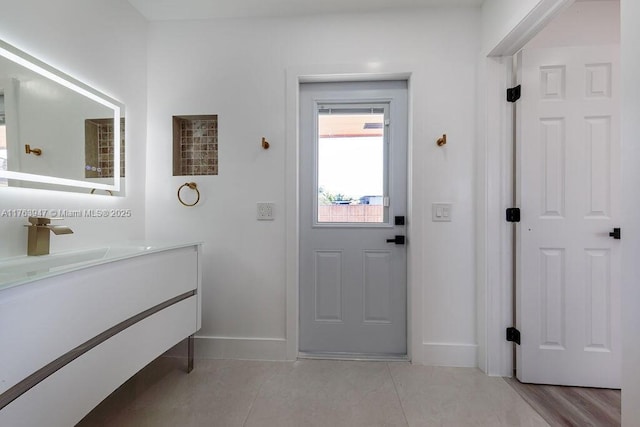 interior space featuring light tile patterned floors and baseboards