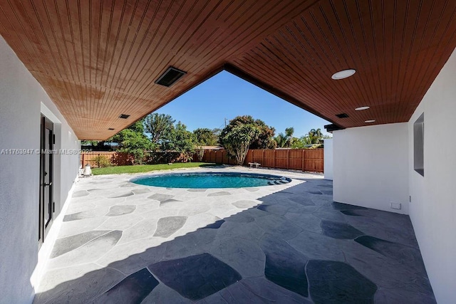 view of pool featuring a fenced in pool, a fenced backyard, and a patio area