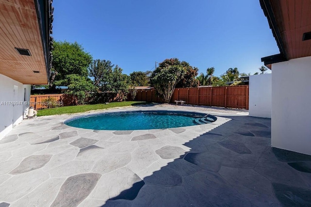 view of pool with a patio and a fenced backyard