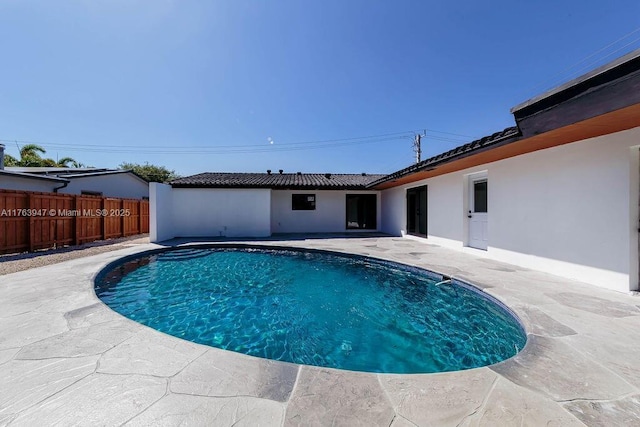 view of pool featuring a patio area, a fenced in pool, and fence