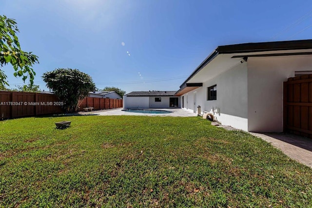 view of yard with a fenced in pool, a patio, and a fenced backyard