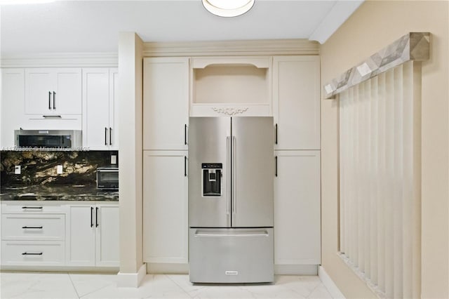 kitchen with dark stone counters, marble finish floor, appliances with stainless steel finishes, and decorative backsplash