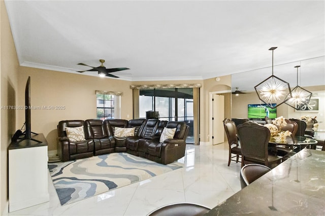 living area with ornamental molding, ceiling fan, and marble finish floor