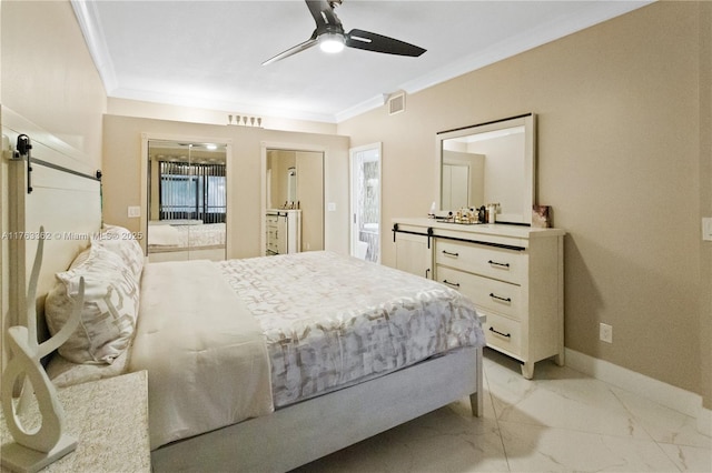 bedroom with ensuite bath, a barn door, marble finish floor, visible vents, and crown molding