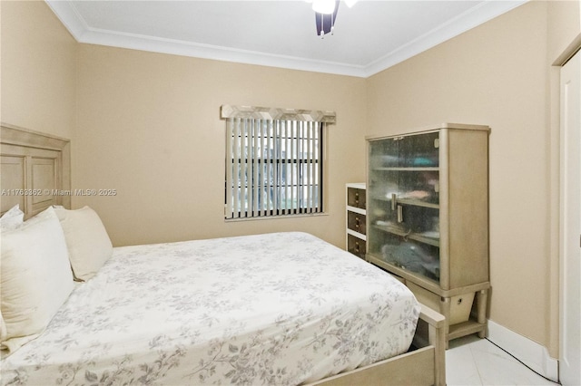 bedroom with tile patterned floors, crown molding, a ceiling fan, and baseboards