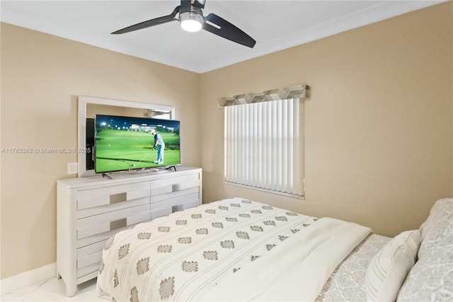 bedroom featuring baseboards and ceiling fan