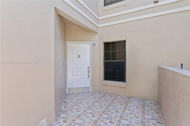 doorway to property with stucco siding