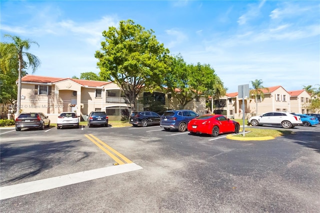 uncovered parking lot featuring a residential view