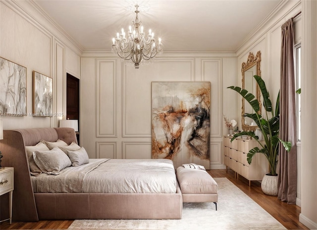 bedroom featuring an inviting chandelier, a decorative wall, and wood finished floors