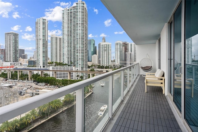 balcony with a water view and a city view