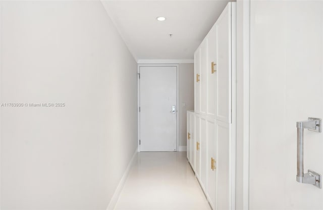 hall with baseboards and recessed lighting