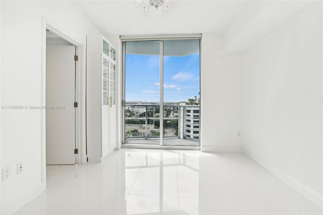 tiled empty room with floor to ceiling windows and baseboards