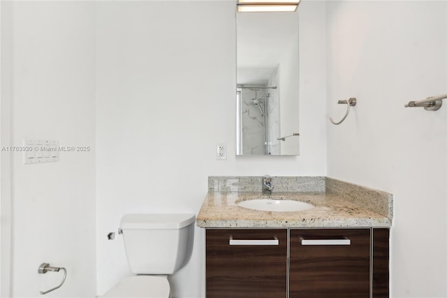 full bath featuring vanity, walk in shower, and toilet