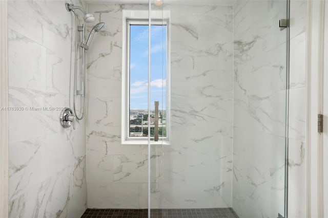 full bathroom featuring a marble finish shower