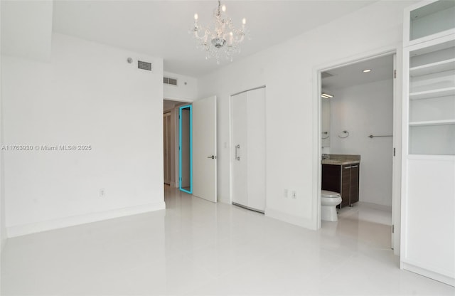 unfurnished bedroom with tile patterned flooring, visible vents, ensuite bathroom, and a chandelier