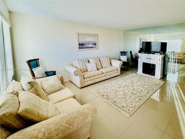 living room with tile patterned floors and a textured ceiling