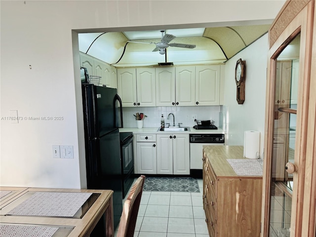 kitchen featuring tasteful backsplash, ceiling fan, light countertops, black appliances, and a sink