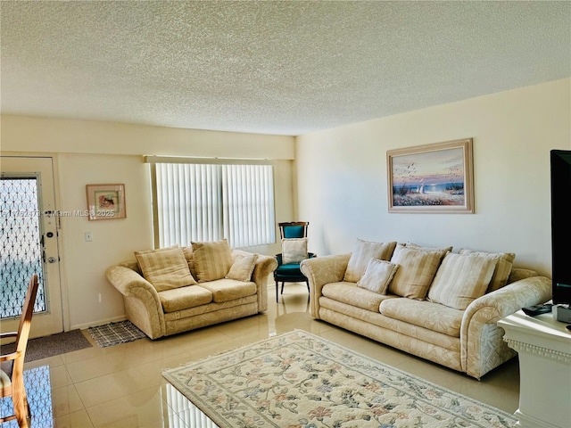 living area featuring light tile patterned floors and a textured ceiling