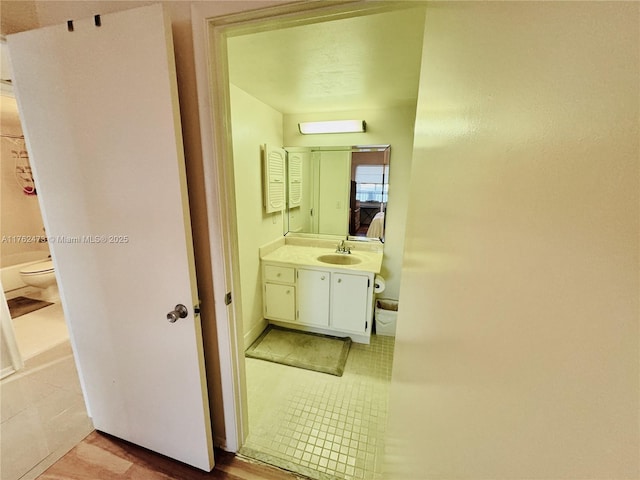 bathroom with tile patterned flooring, toilet, and vanity