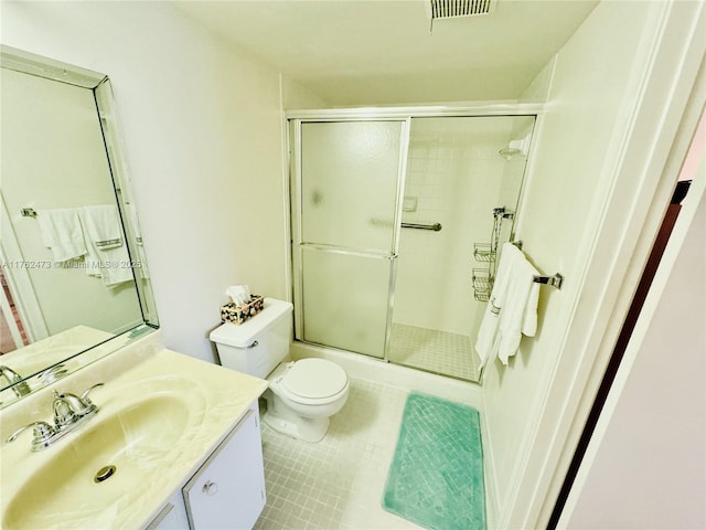 full bathroom with vanity, visible vents, tile patterned flooring, toilet, and a shower with door