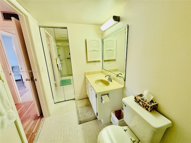 bathroom with visible vents, toilet, and vanity